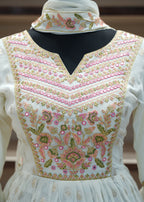 White embroidered blouse with floral patterns on a blurred background