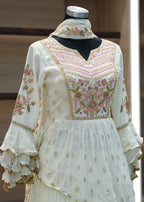 Vintage dress on a mannequin with intricate embroidery in a blurred indoor setting