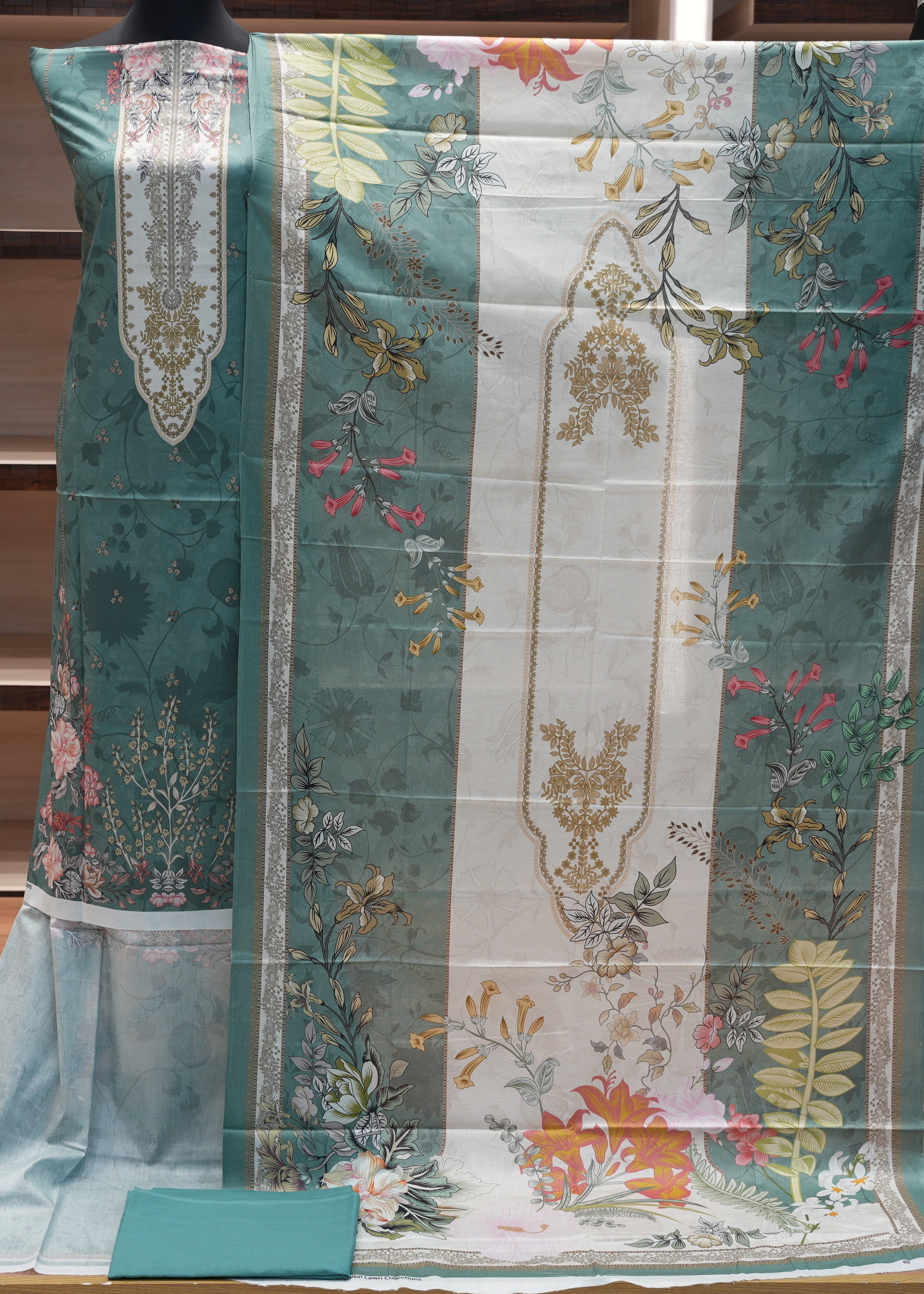 Floral and geometric patterned fabric on a mannequin with a wooden shelf background