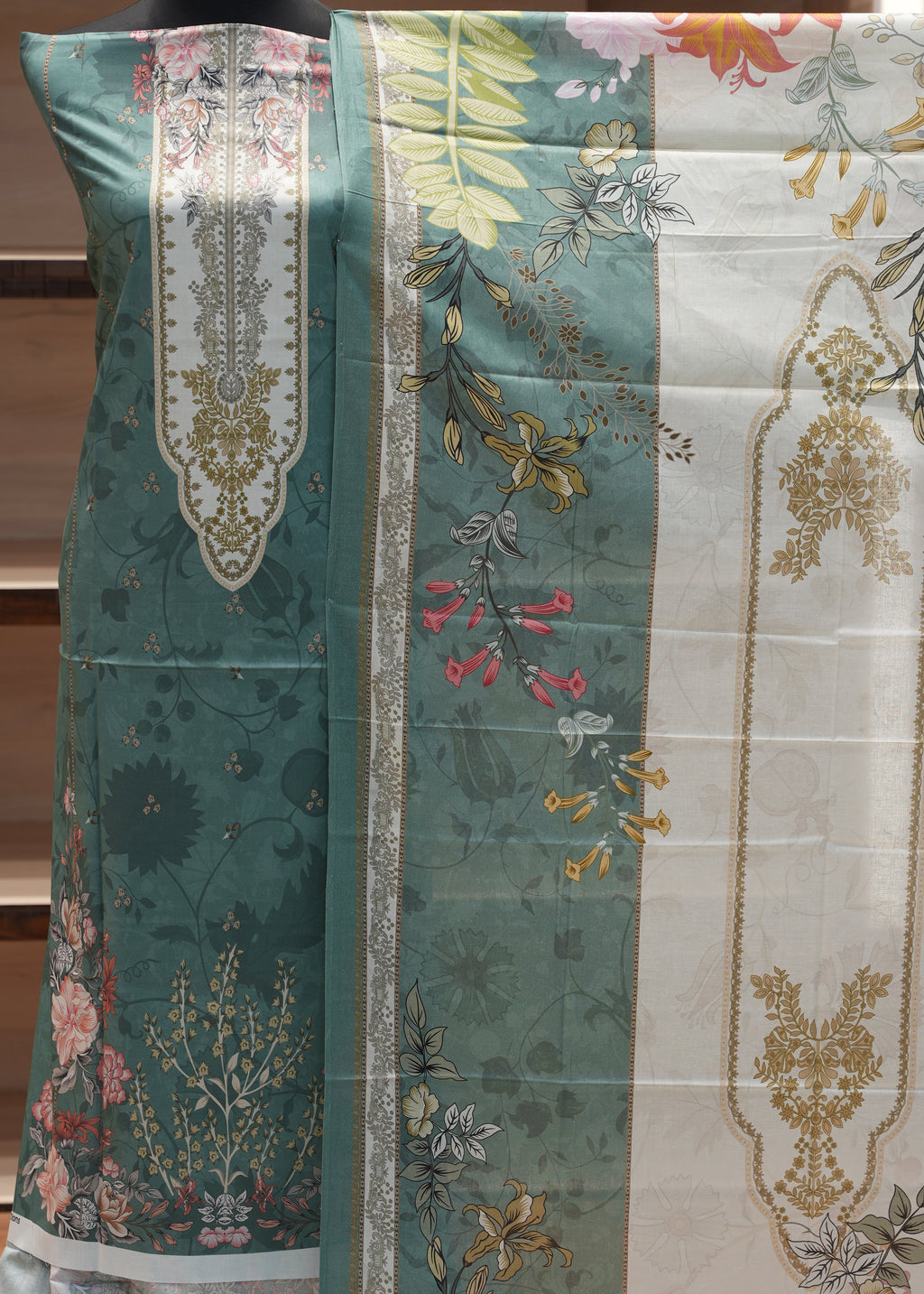 Decorative pillow with floral and geometric patterns on a wooden background