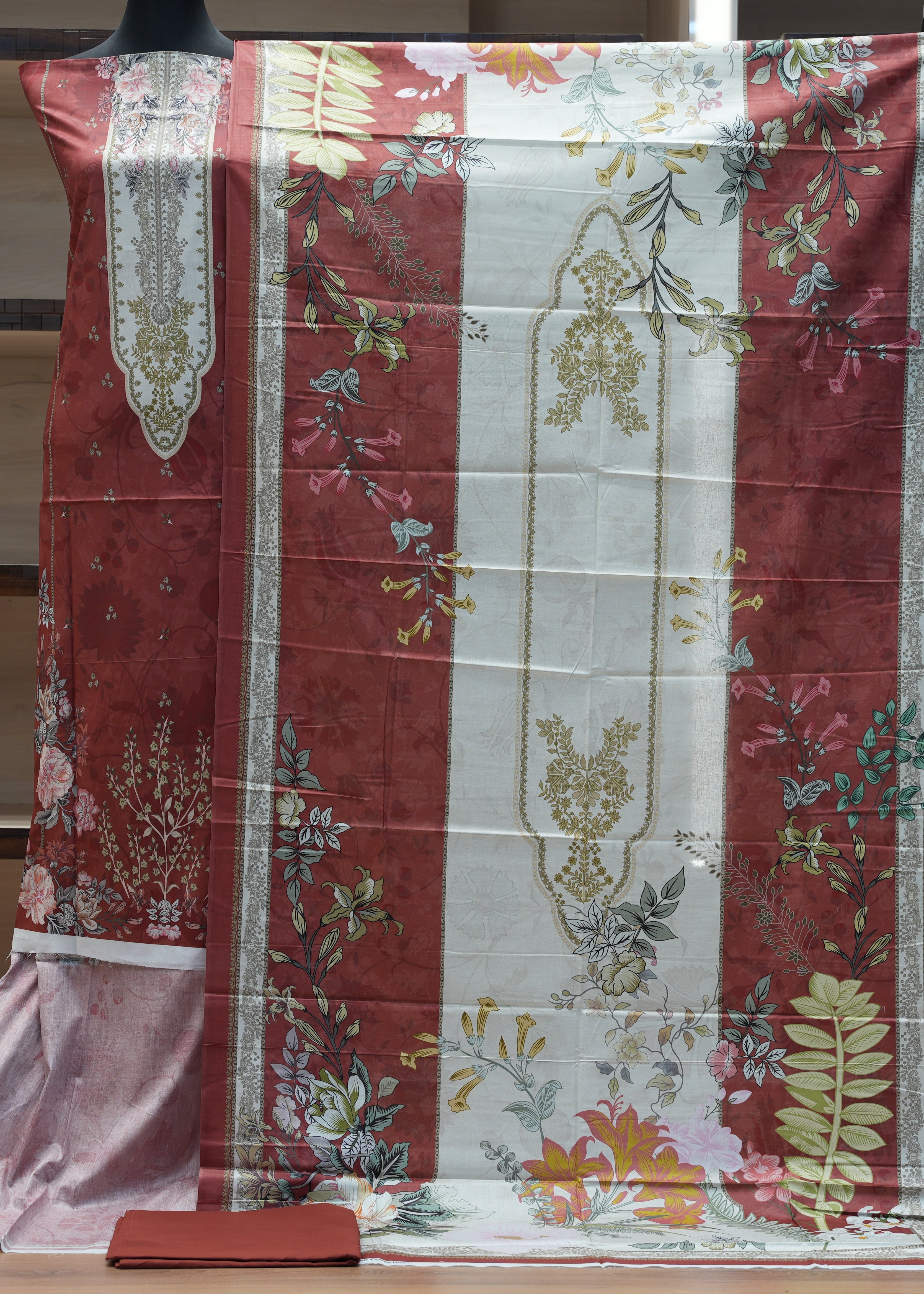 Floral patterned fabric draped over a mannequin in a minimal indoor setting.