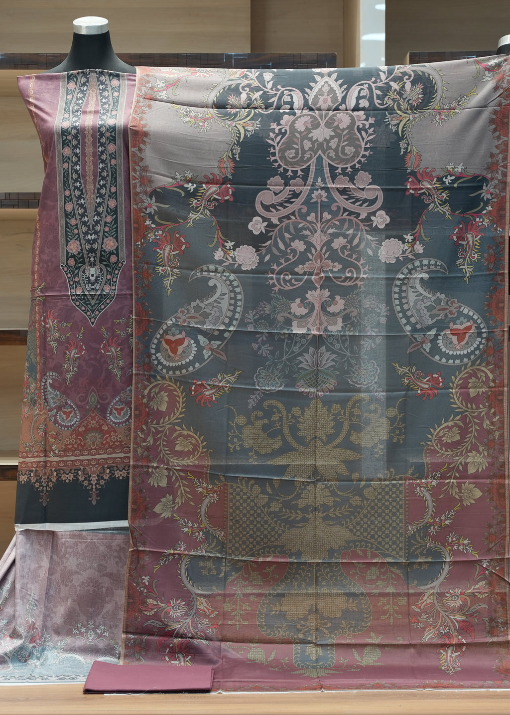 Decorative fabric with intricate patterns on a mannequin against a neutral background