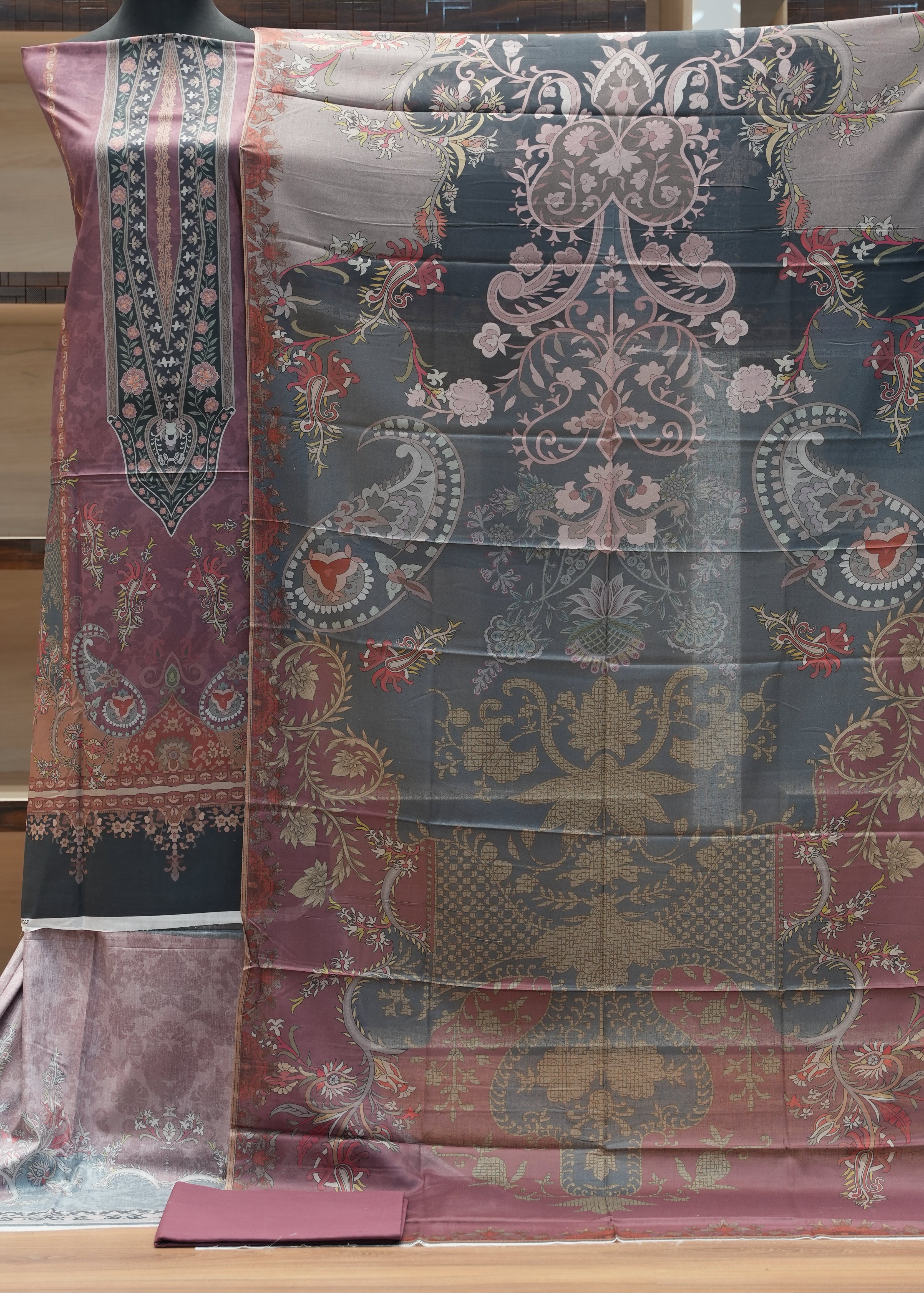 Decorative fabric with intricate patterns on a wooden surface