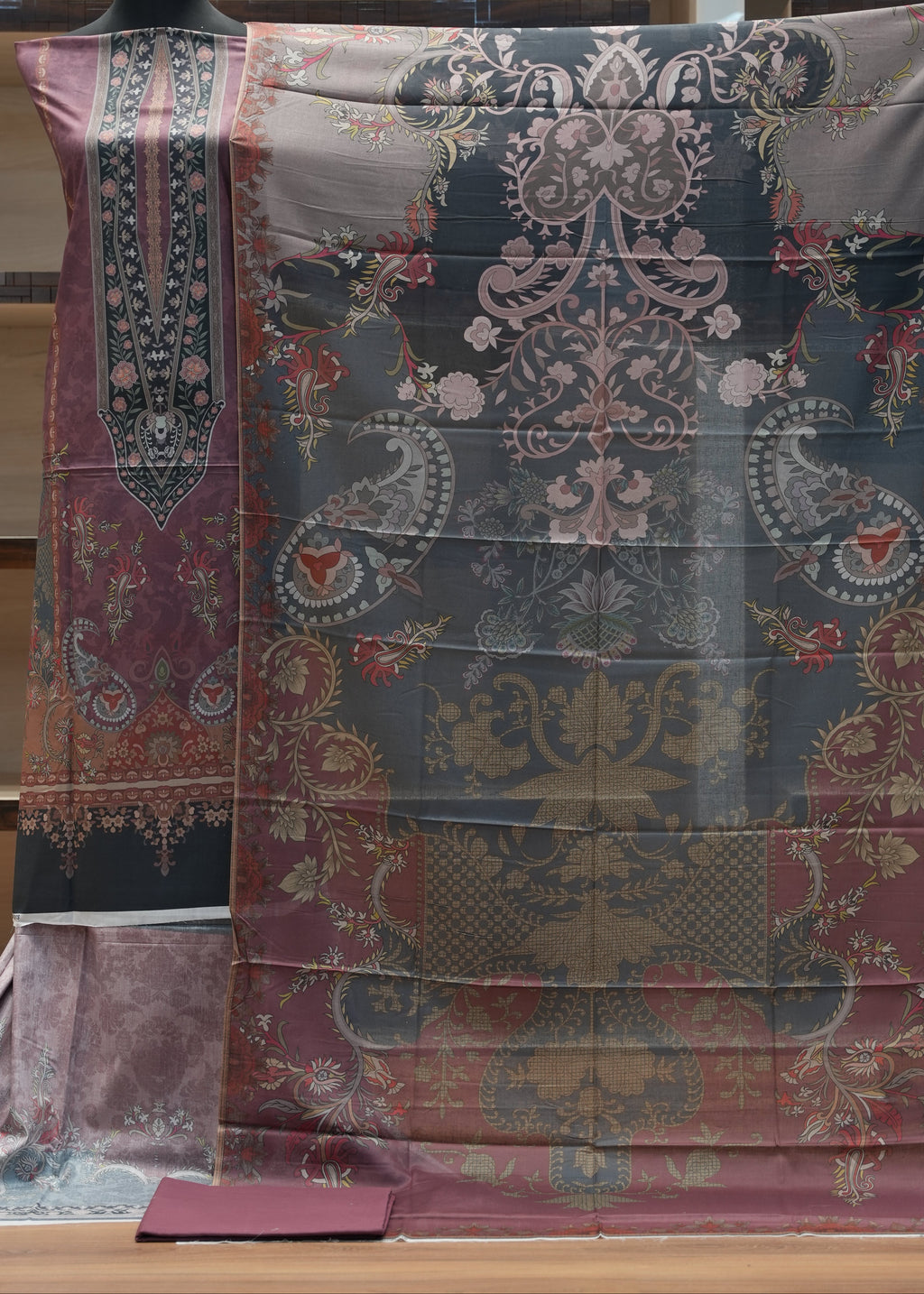 Decorative fabric with intricate patterns on a wooden surface