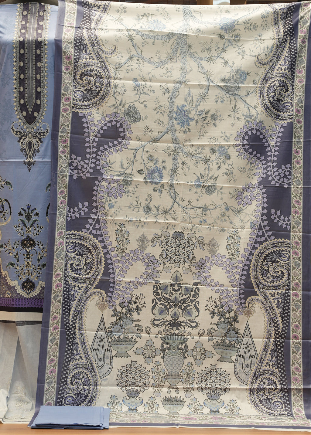 Decorative tablecloth with paisley pattern on a wooden chair