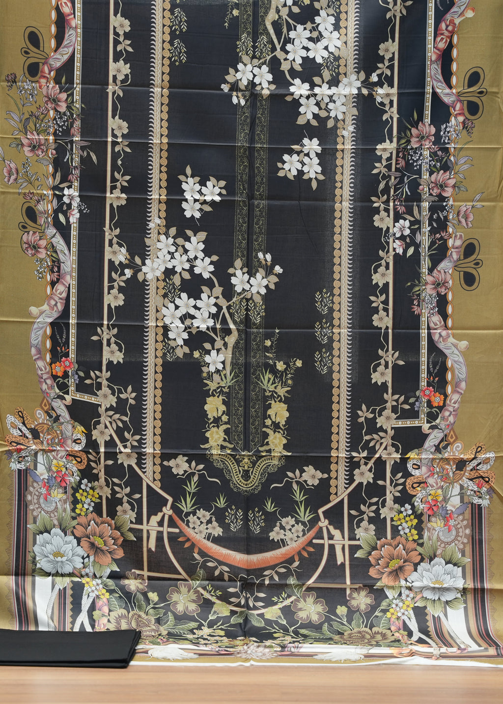 Decorative fabric with intricate patterns on a wooden surface