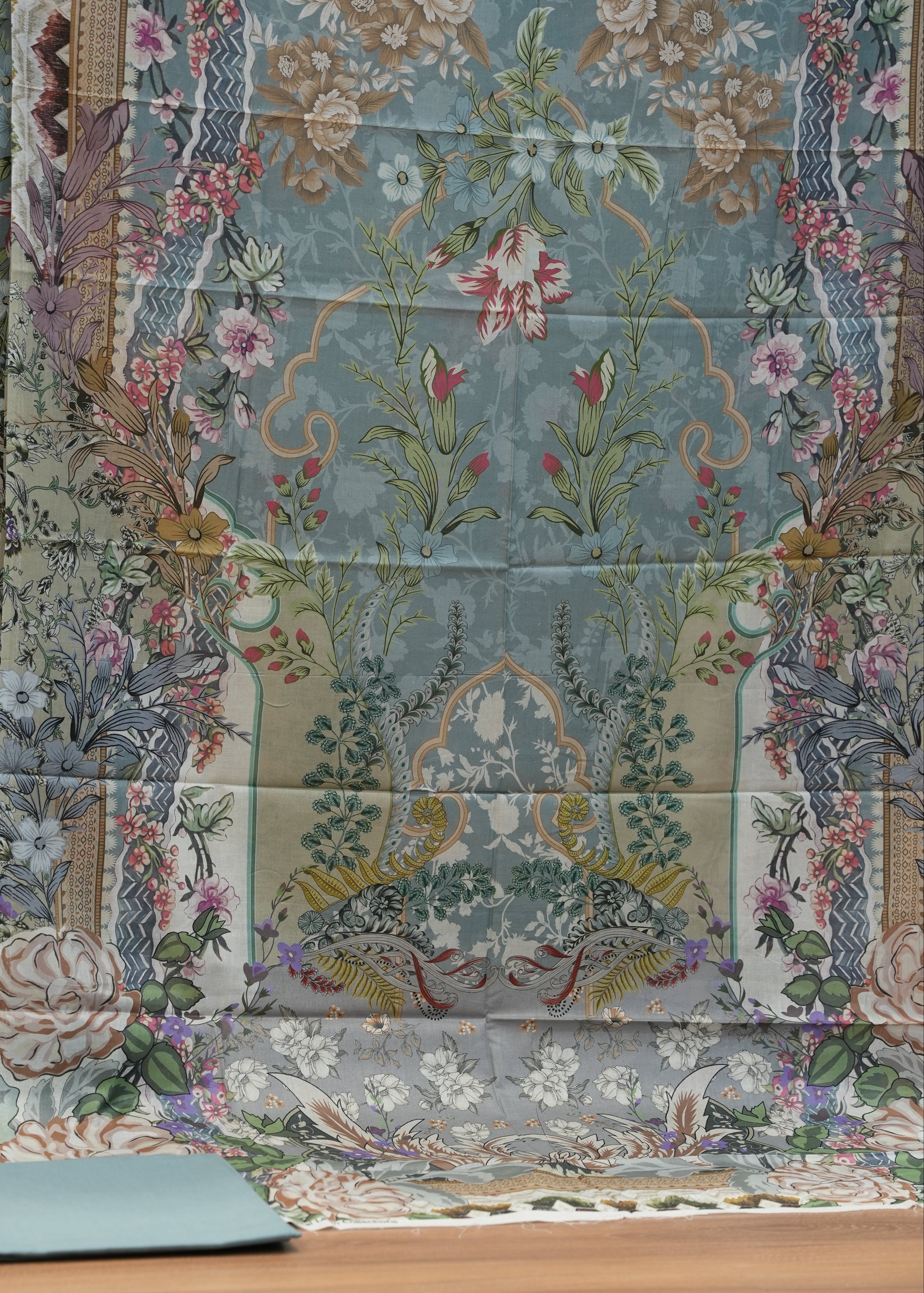 Patterned fabric with floral and animal designs on a quilt