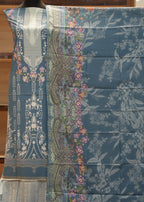 Decorative fabric with floral and paisley patterns on a wooden surface