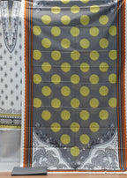 Decorative pillow with yellow polka dots on a gray background, displayed against a wooden panel.