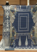 Decorative fabric with intricate patterns on a mannequin against a wooden background