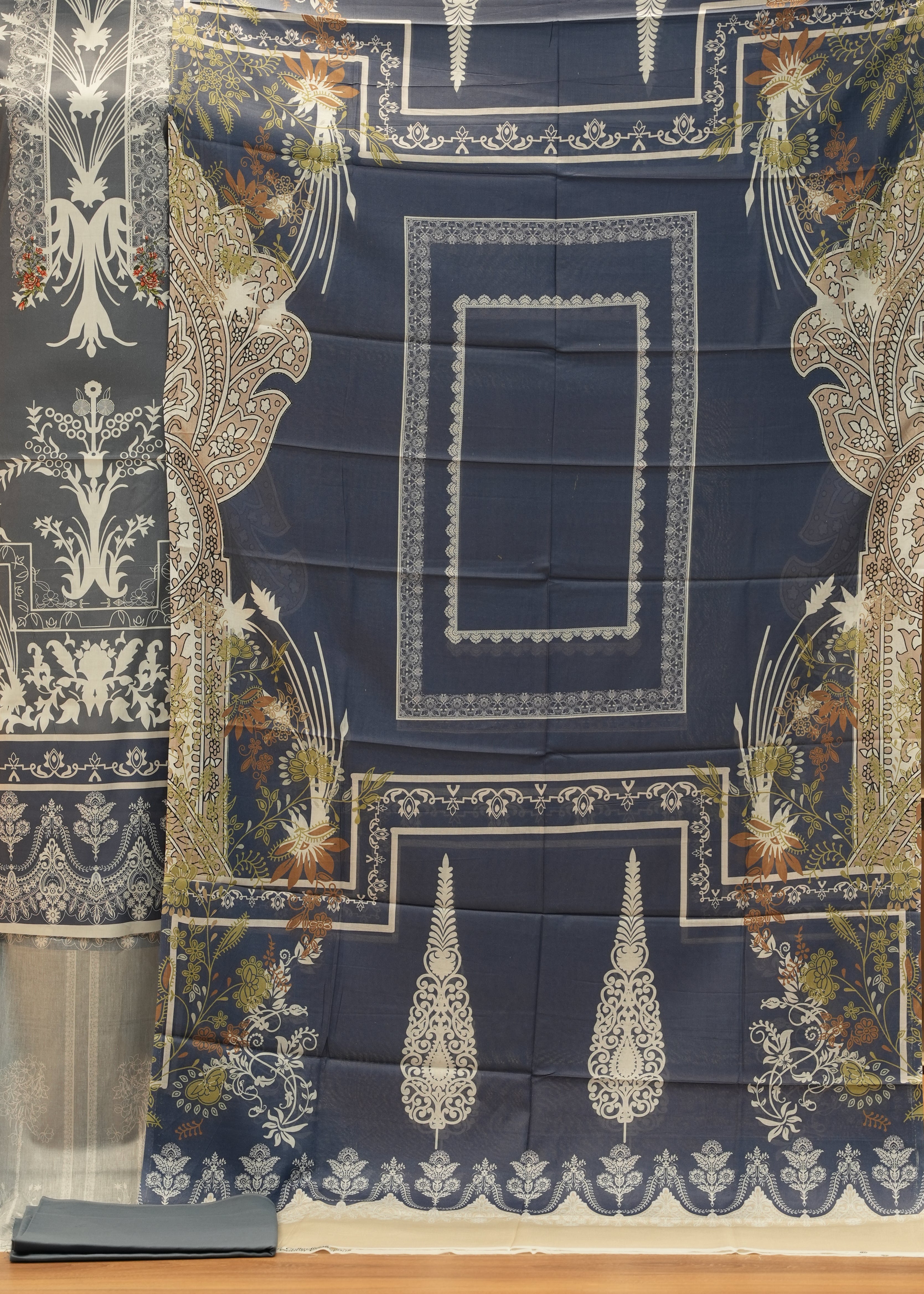 Decorative tablecloth with intricate patterns on a wooden surface