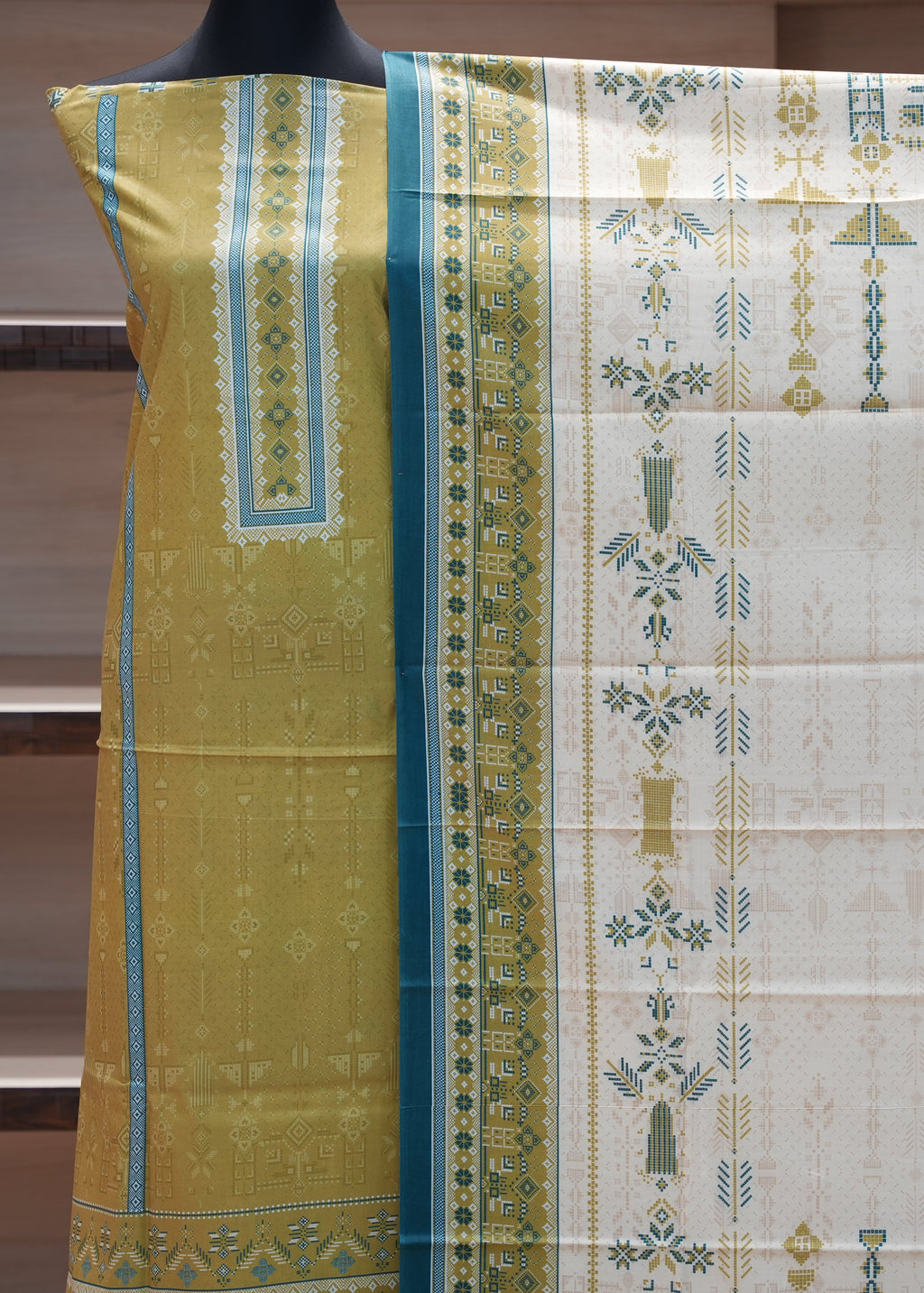 Saree with green and white patterned border on a mannequin