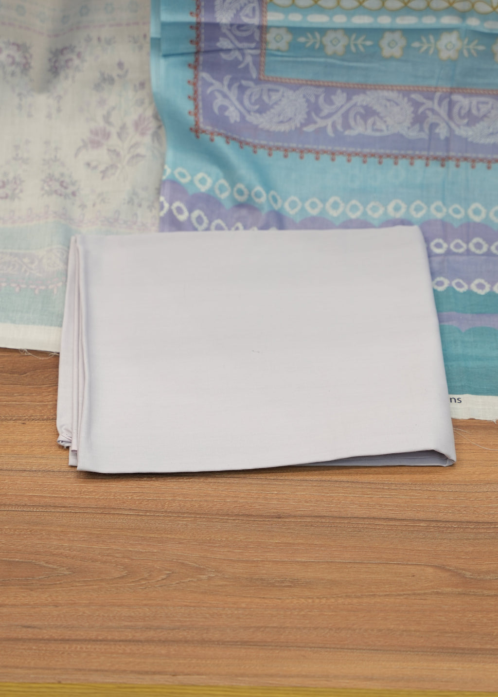 Collection of patterned fabrics on a wooden surface