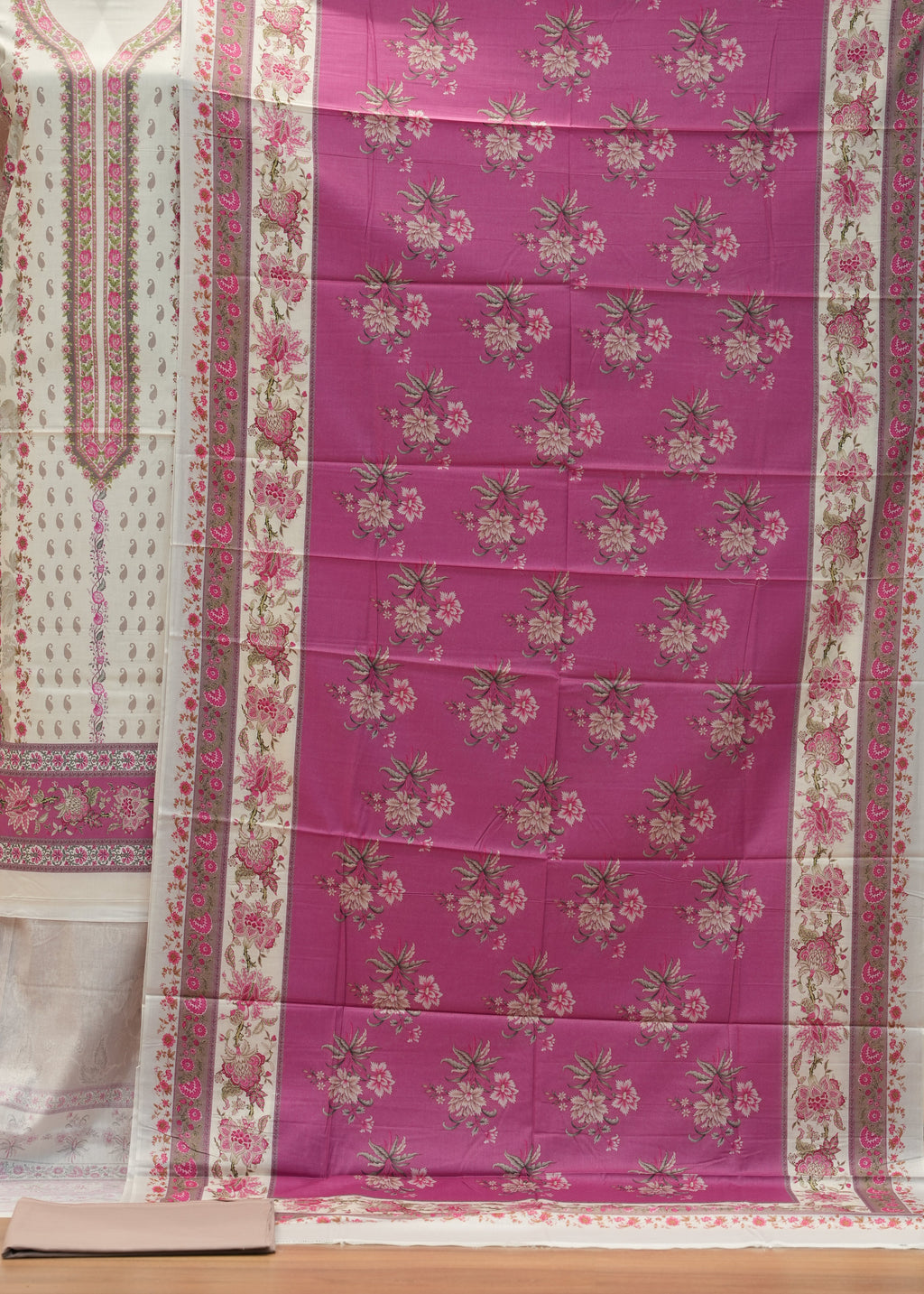 Purple floral patterned fabric draped over a chair with a white border.