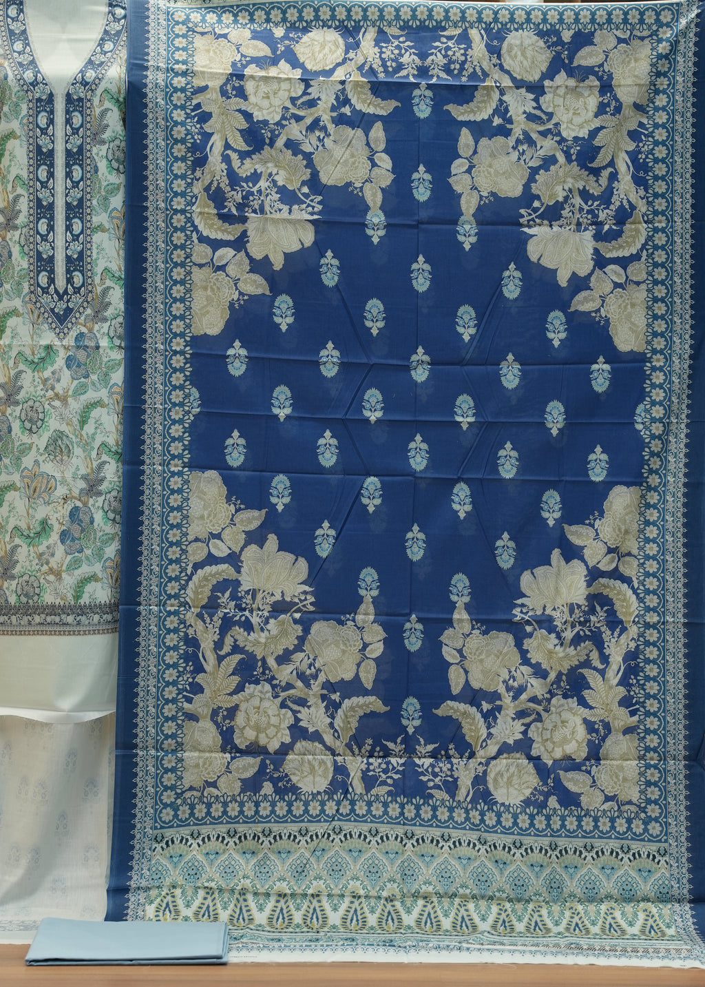 Blue floral patterned fabric on a wooden surface