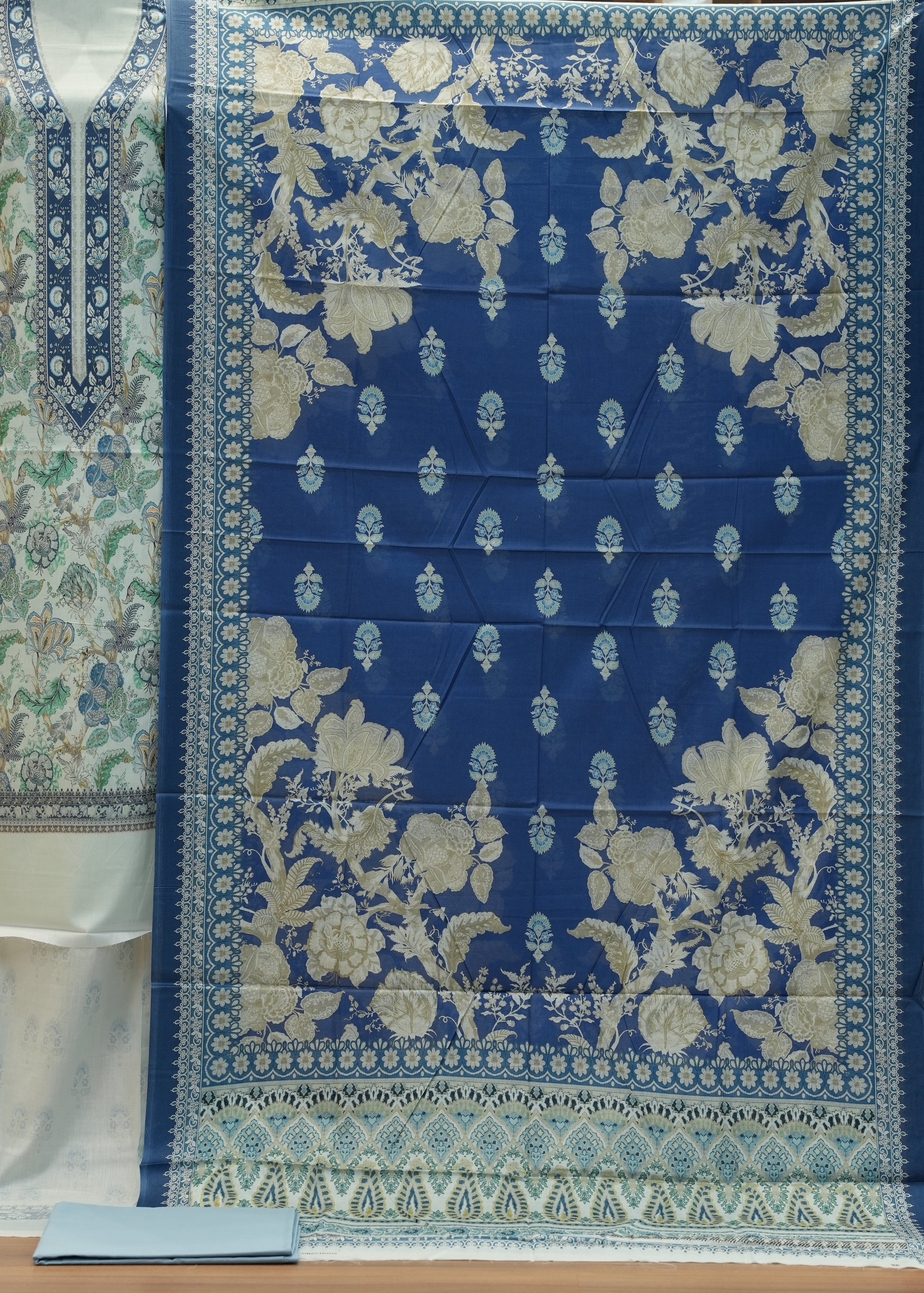 Blue floral patterned fabric on a wooden surface