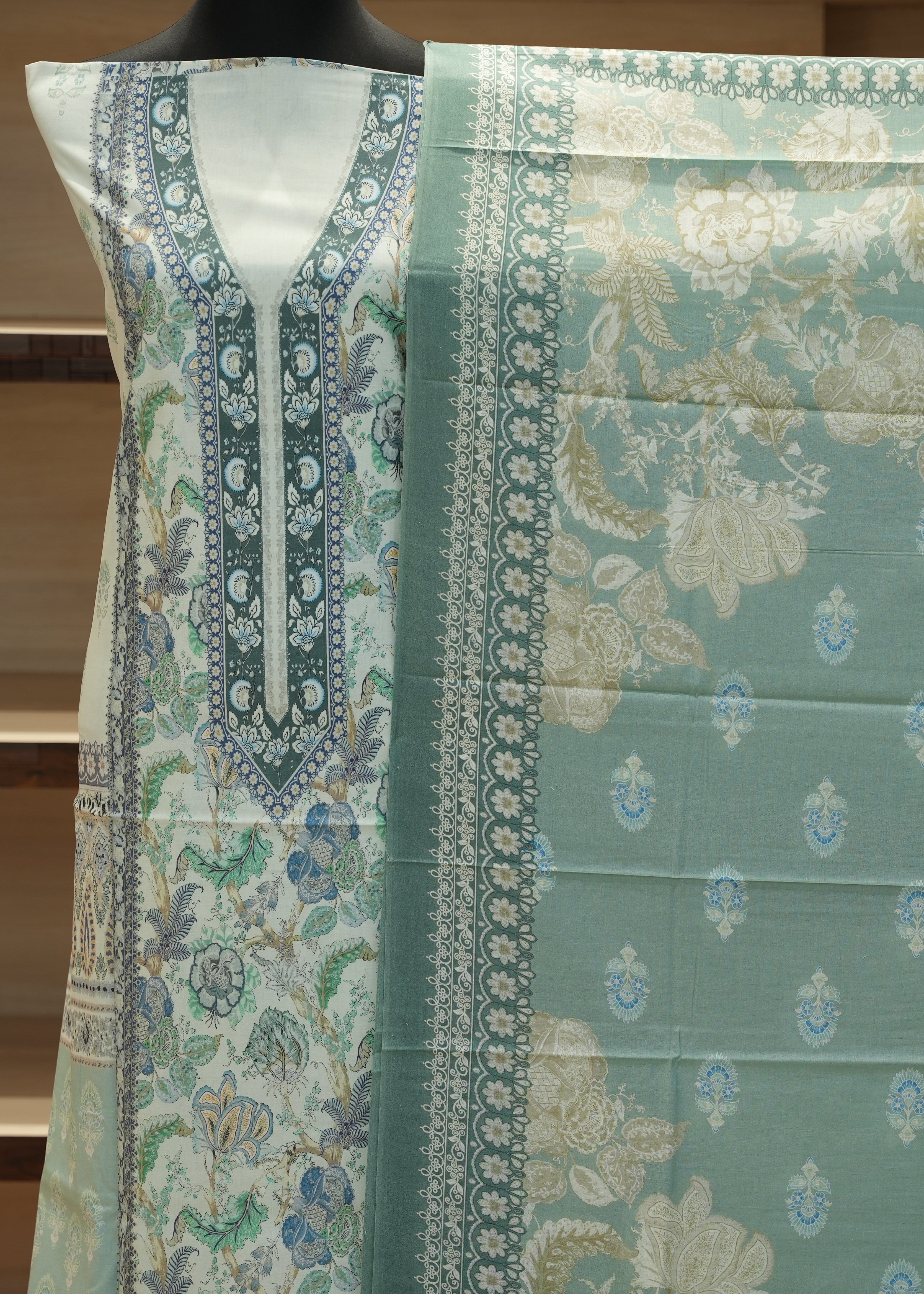 Teal fabric with floral patterns on a mannequin