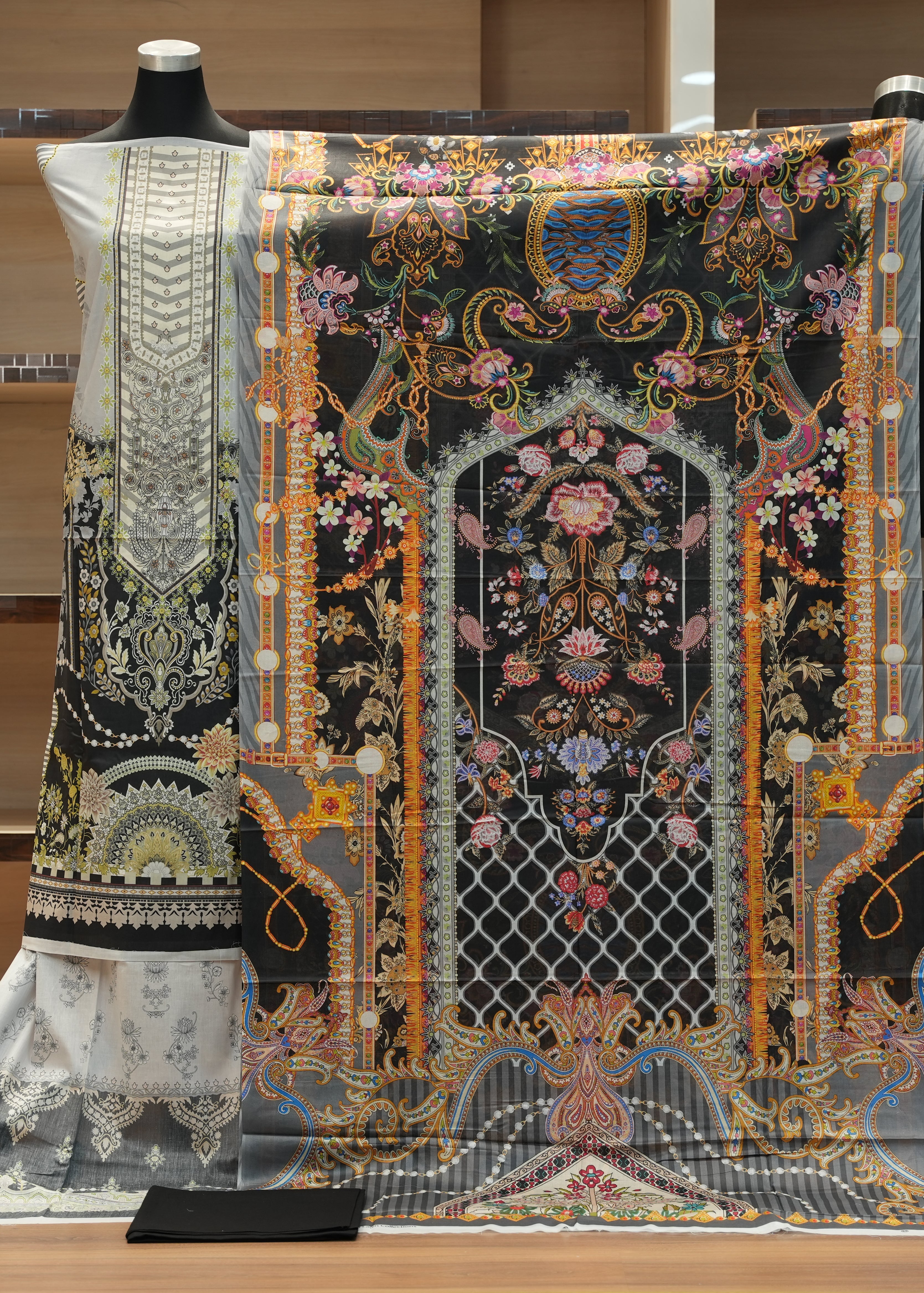 Decorative fabric with intricate patterns on a mannequin against a neutral background
