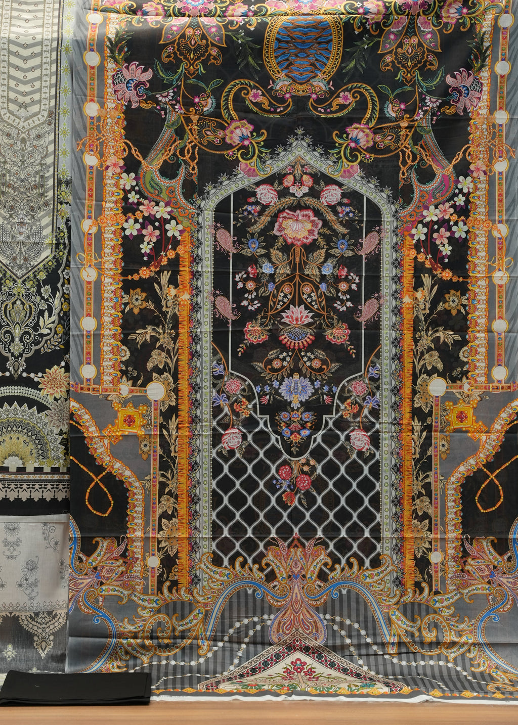 Decorative fabric with intricate patterns on a wooden surface