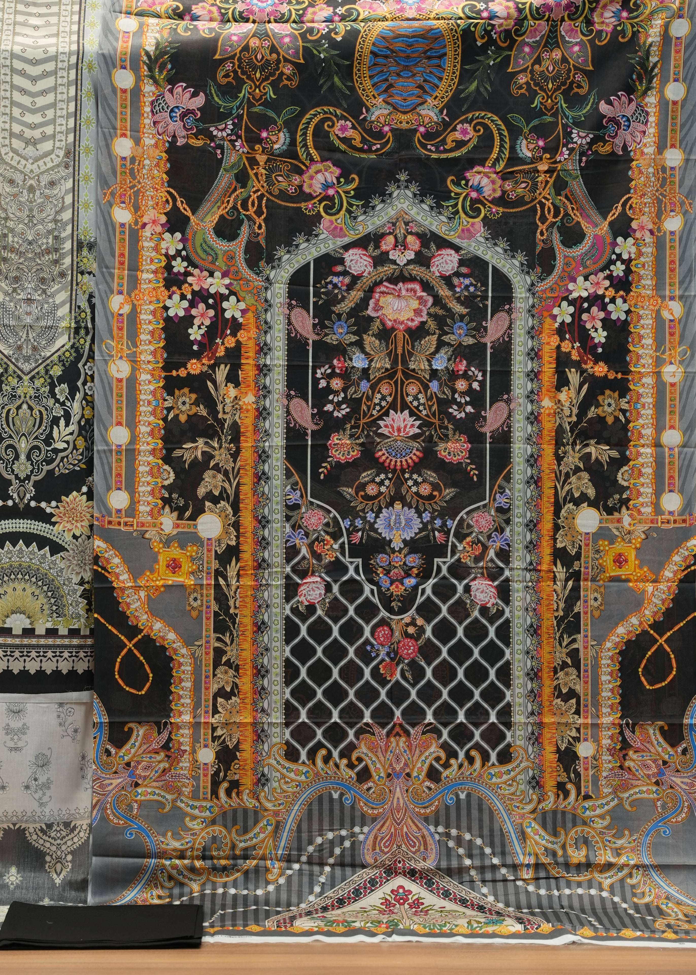 Decorative fabric with intricate patterns on a wooden surface