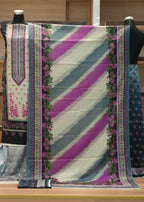 Colorful fabric with floral patterns draped over a mannequin against a wooden background