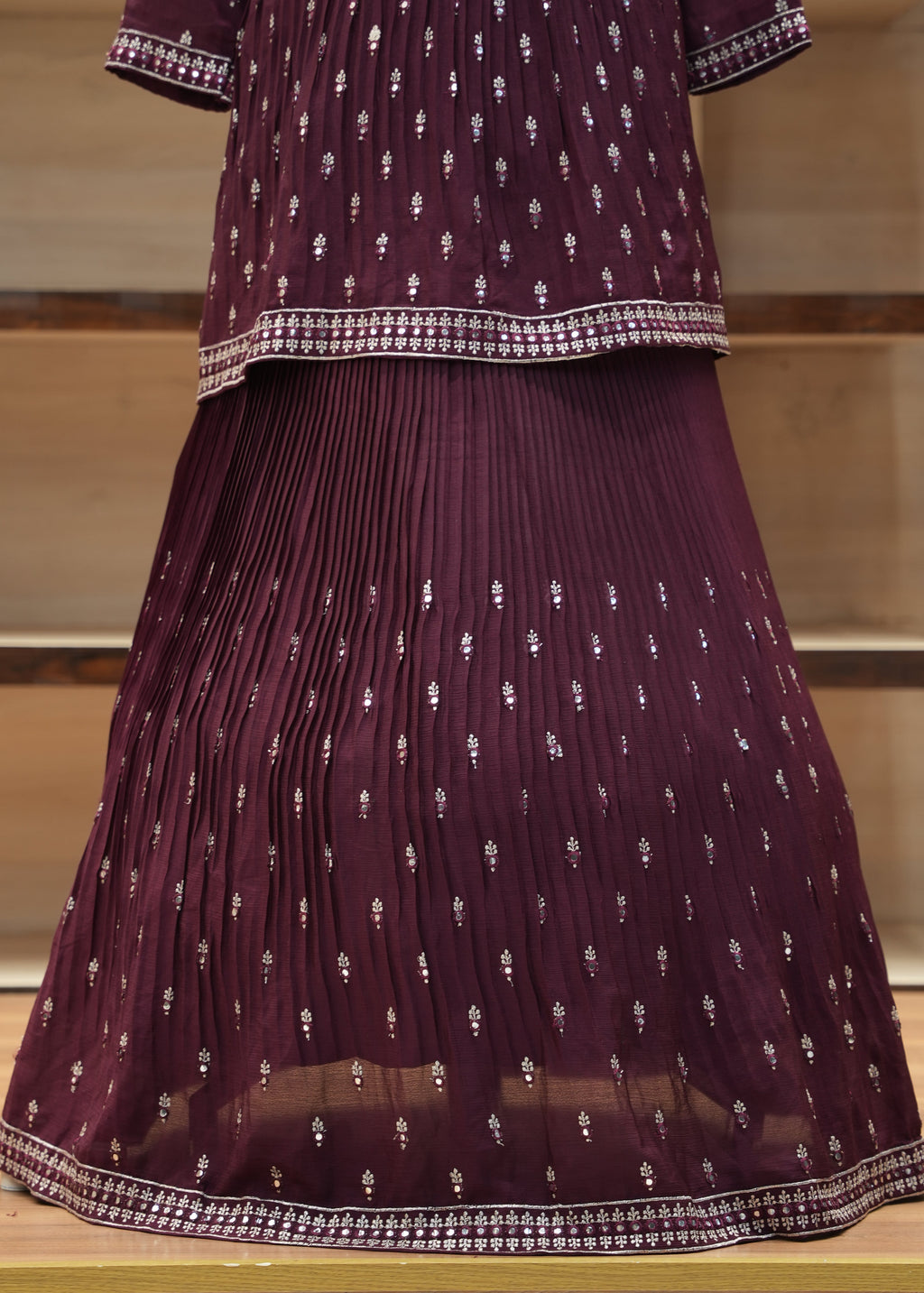 Purple saree with white patterns on a wooden stand