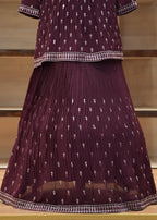 Purple saree with white patterns on a wooden stand