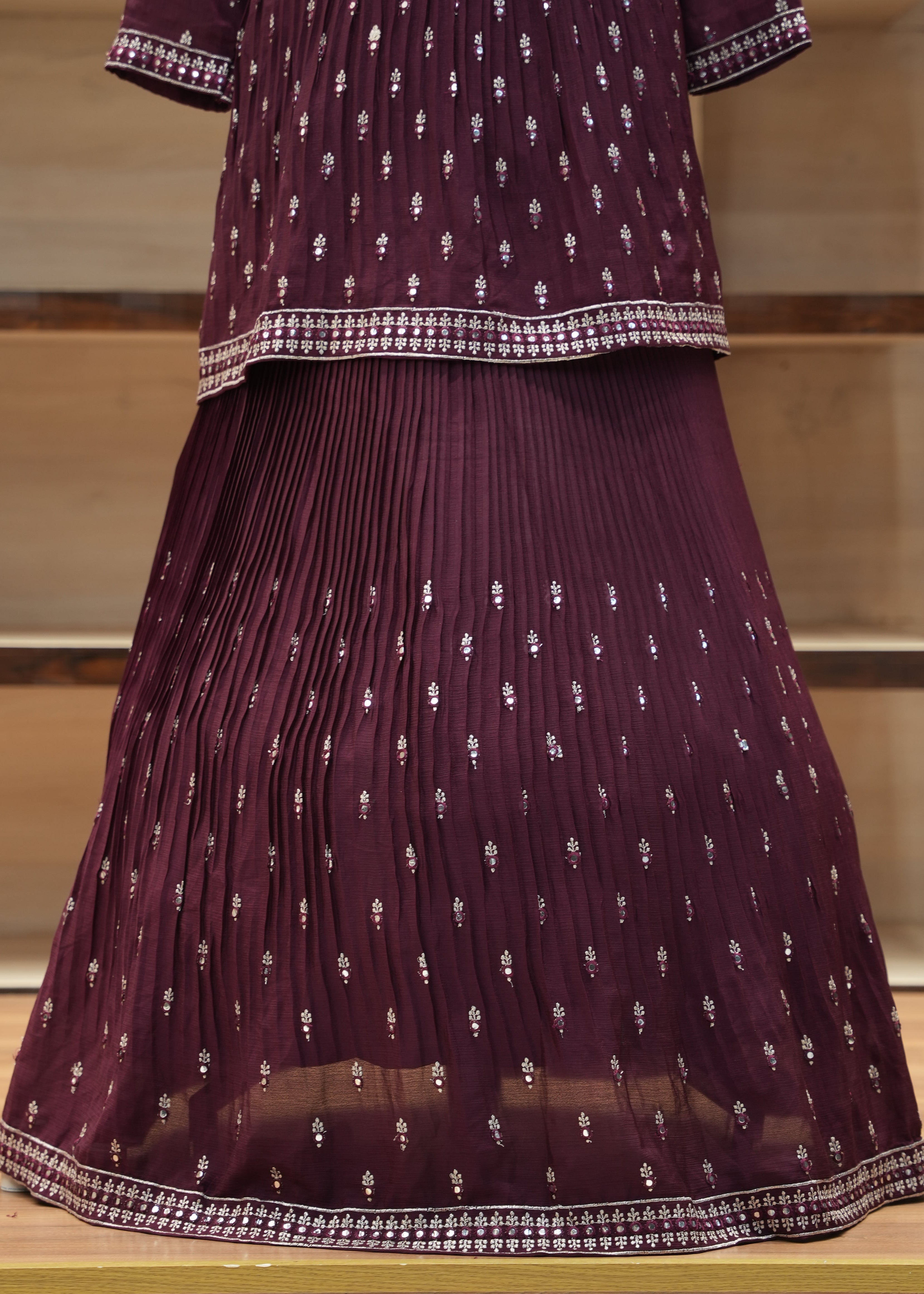 Purple saree with white patterns on a wooden stand