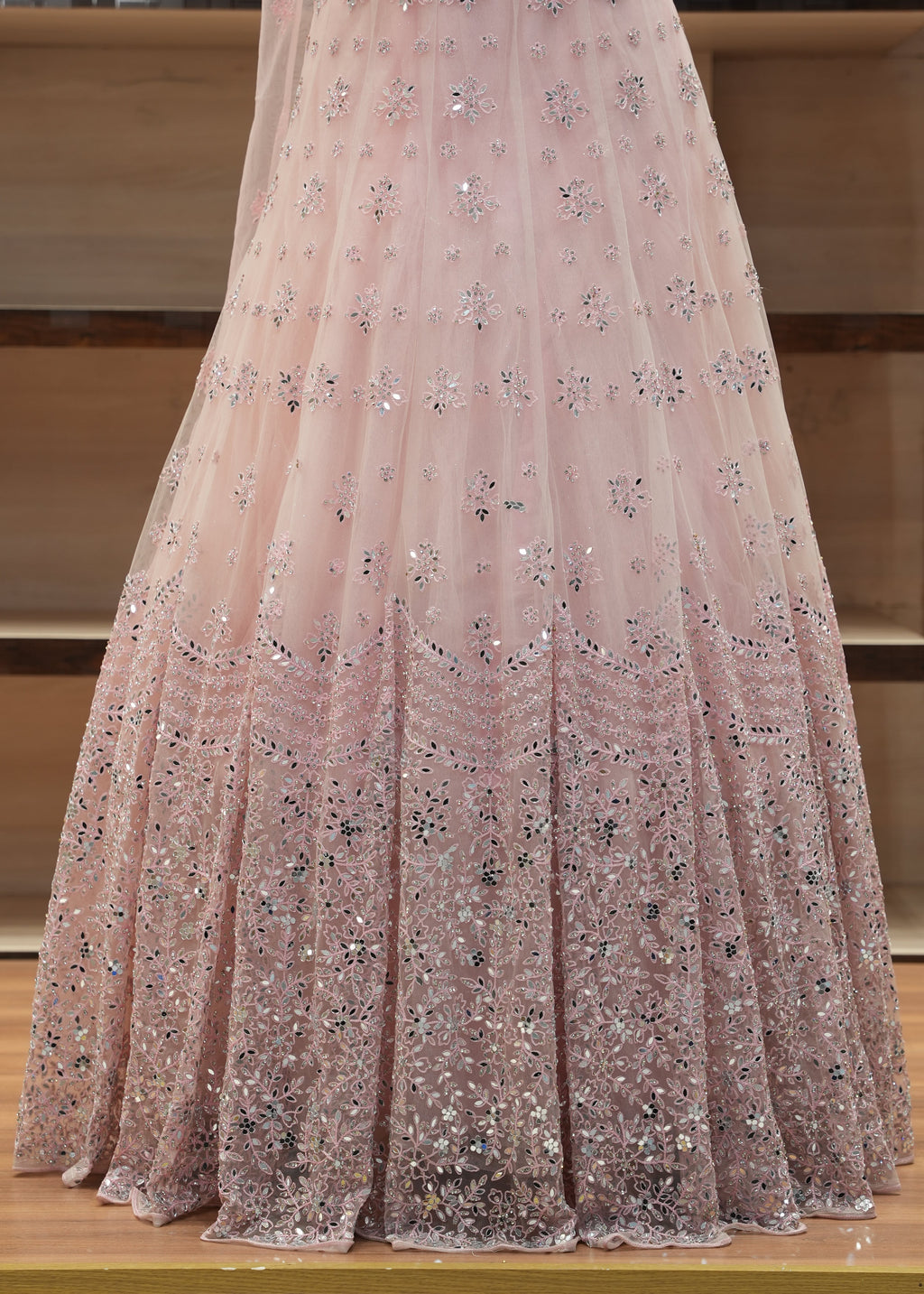 Pink glittery fabric draped over a wooden surface