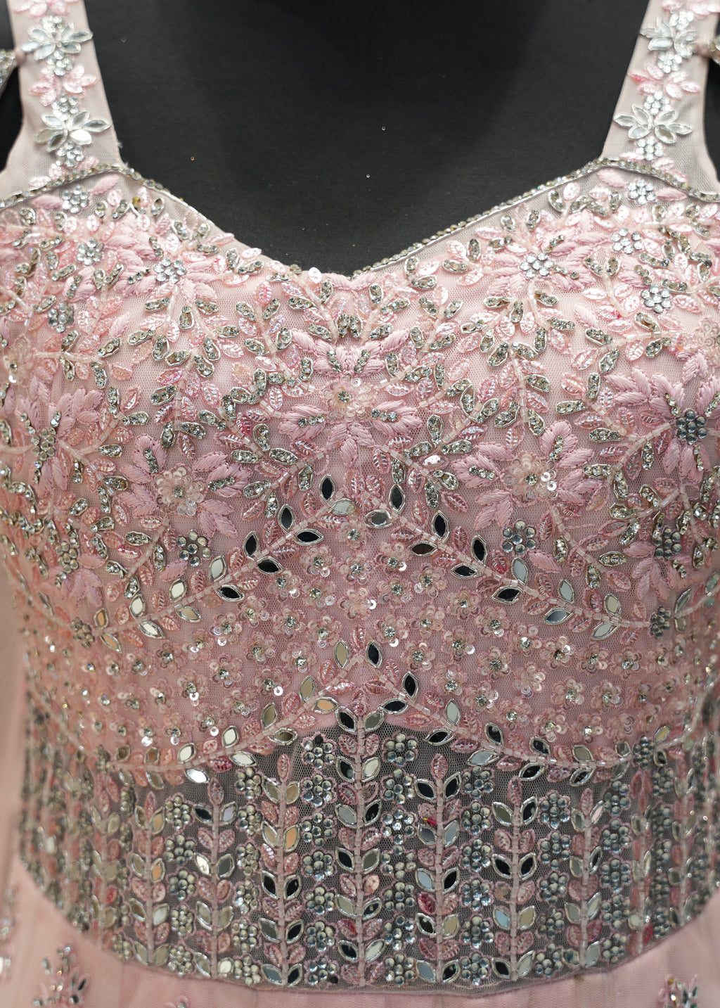 Pink beaded top on a mannequin with a blurred background