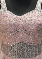 Pink beaded top on a mannequin with a blurred background