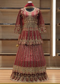 Decorative red and gold garment on a mannequin against a wooden background