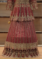Decorative red and gold traditional outfit on a wooden floor