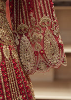 Close-up of red fabric with gold embroidery on a blurred background