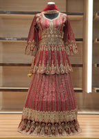 Decorative red and gold traditional outfit on a mannequin against a wooden background