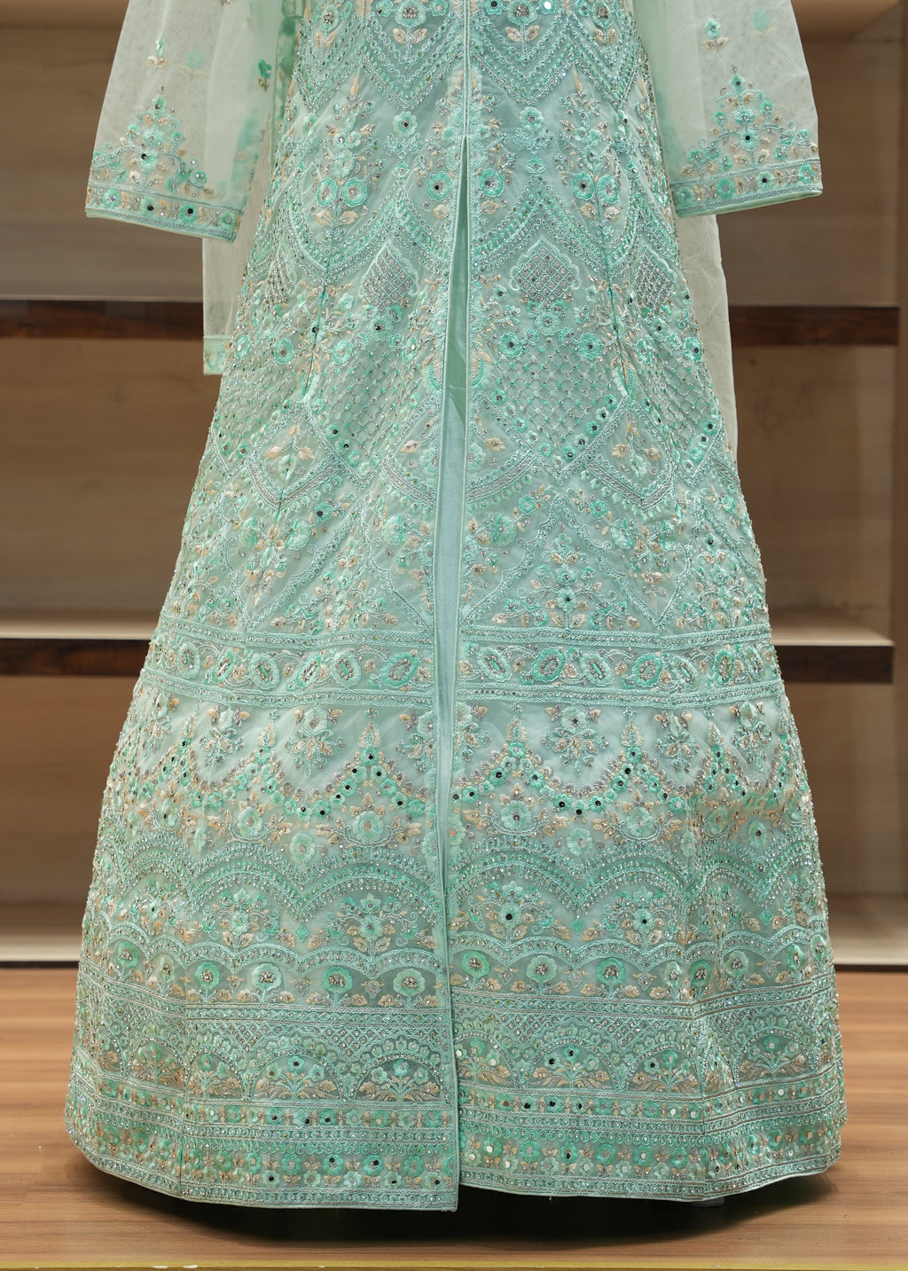 Teal embroidered fabric on a wooden stand