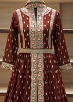 Maroon embroidered traditional dress on a mannequin against a neutral background