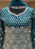 Teal embroidered traditional outfit with a matching dupatta on a neutral background