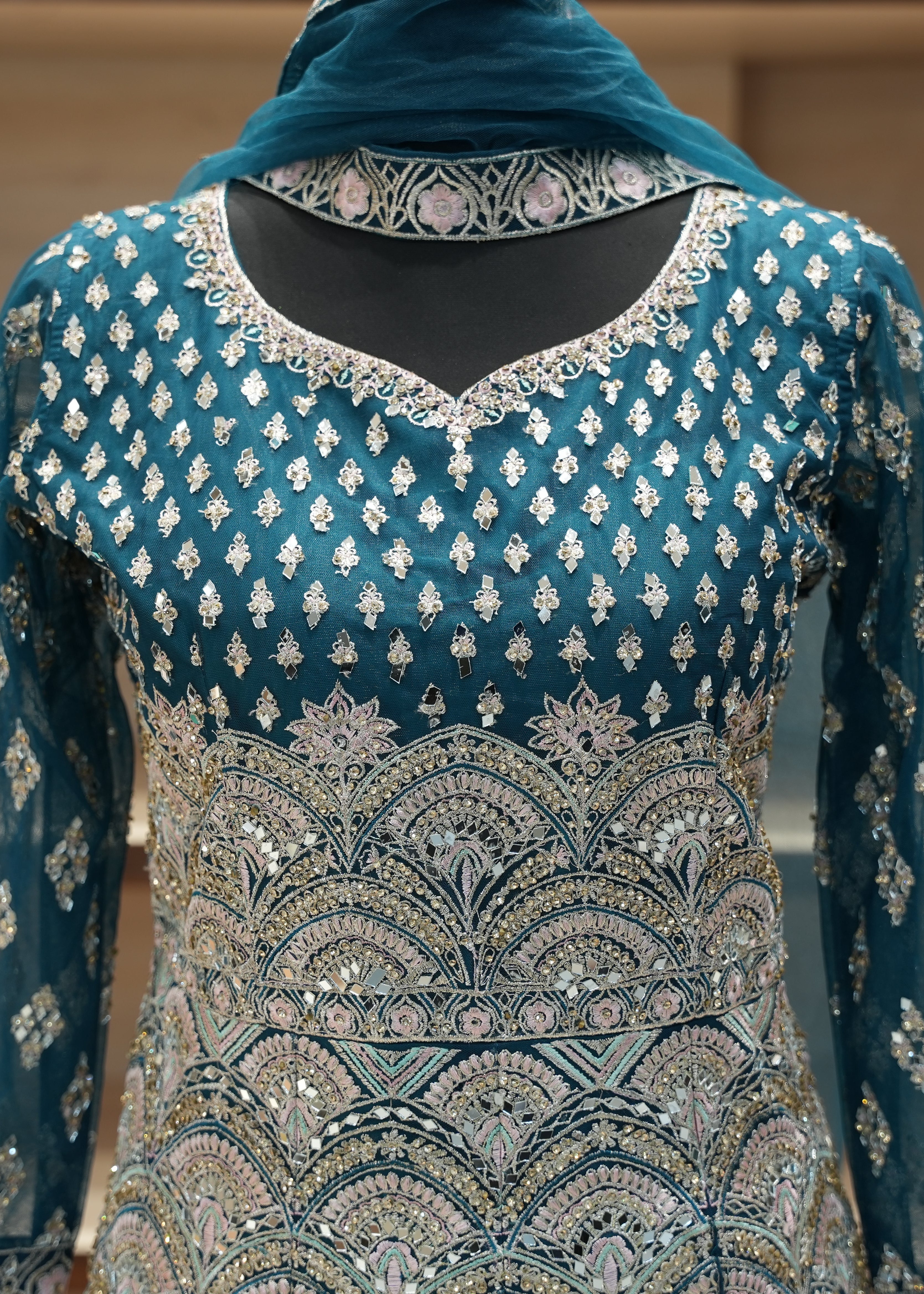 Teal embroidered traditional outfit with a matching dupatta on a neutral background