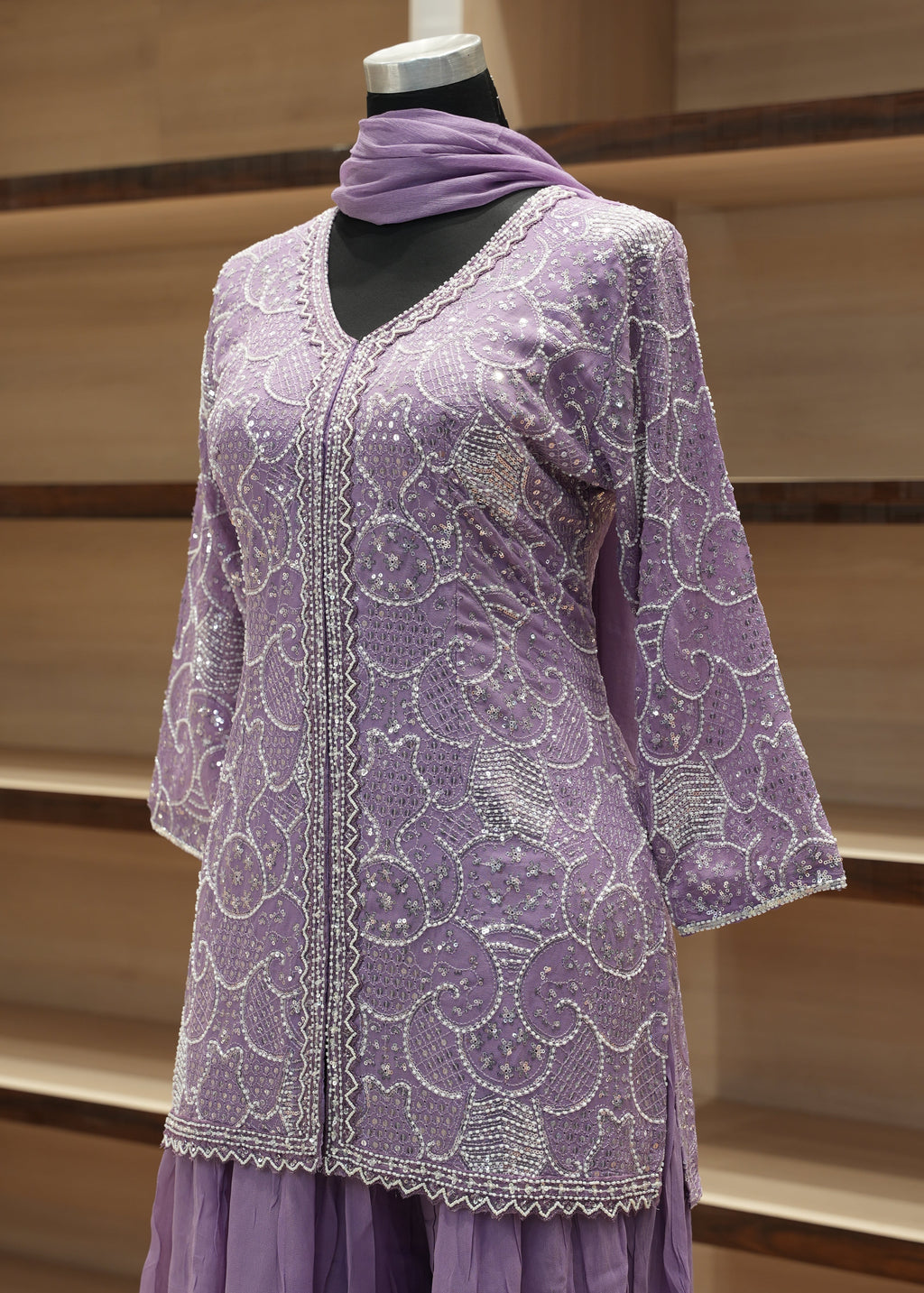 Purple lace gloves on a wooden rack