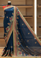 Blue saree with intricate patterns on a wooden shelf background