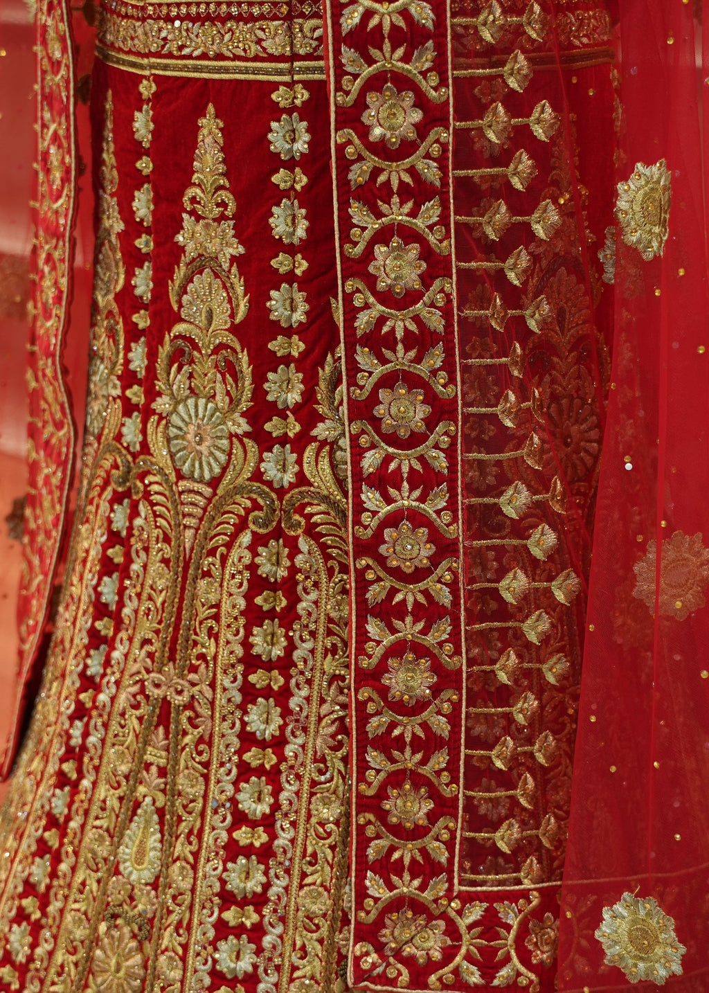 Red embroidered fabric with gold patterns