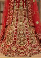 Red and gold embroidered traditional outfit on a wooden floor