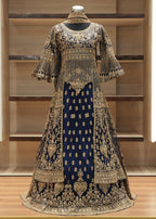 Elegant embroidered dress on a mannequin against a wooden background