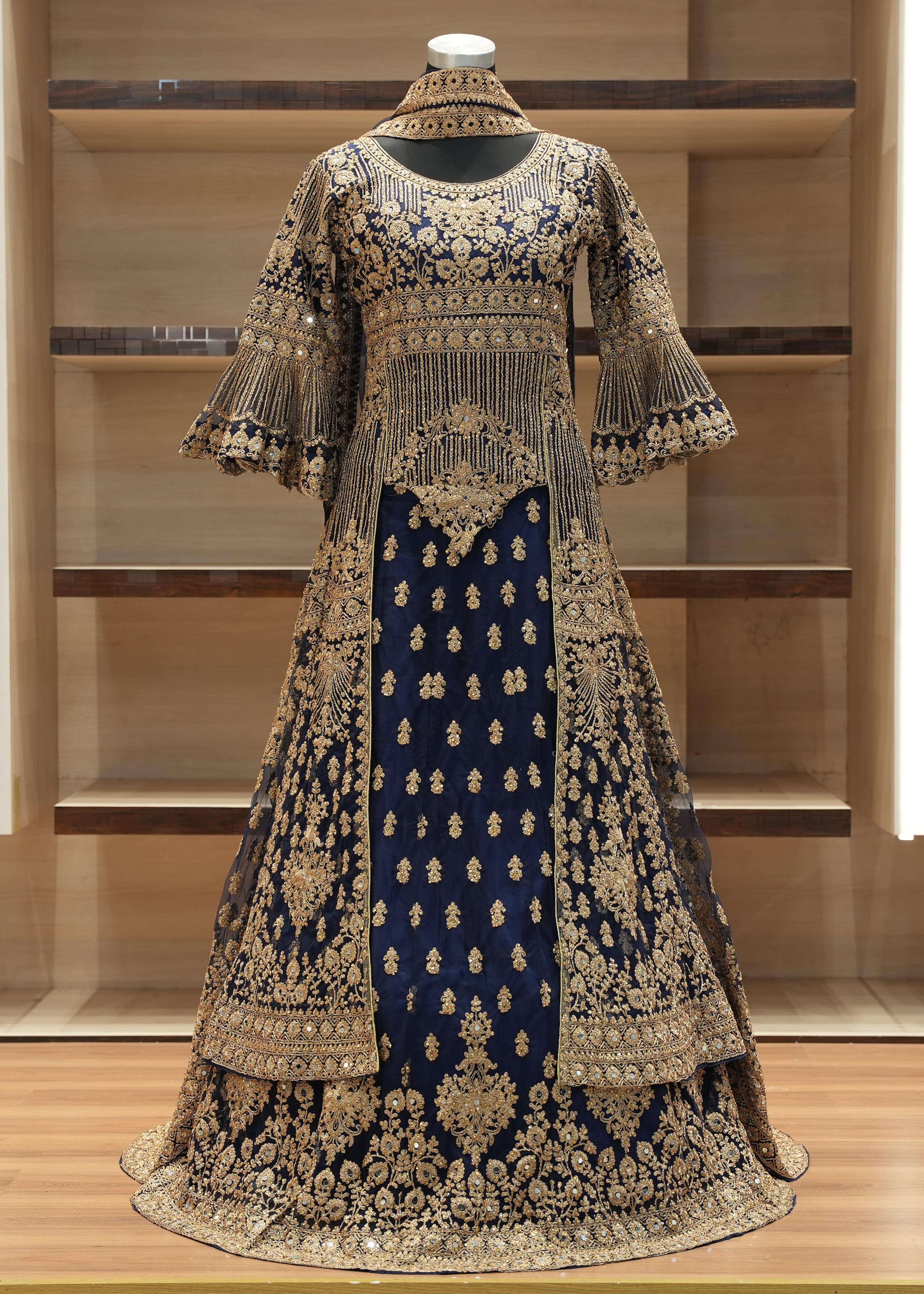 Elegant embroidered dress on a mannequin against a wooden background
