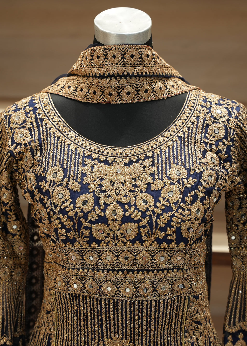 Elegant embroidered garment on a mannequin with a neutral background