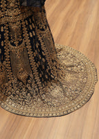Decorative fabric with intricate gold patterns on a wooden floor