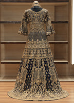 Elaborately designed dress with intricate patterns on a wooden floor.