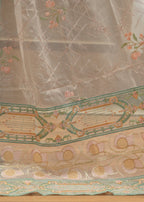 Embroidered fabric with floral and geometric patterns on a wooden surface