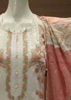 Embroidered traditional outfit with floral patterns on a mannequin.